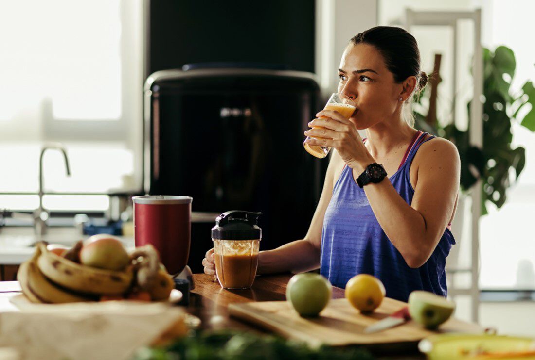 Woman drinks smoothie to support her immune health.